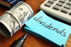 dividends concept stack of dollars and calculator 138921916