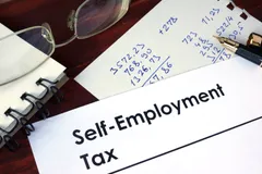 paper with words self employment tax 100242237