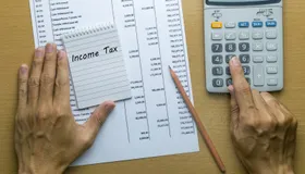 man planning monthly income tax 79108725