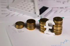 paper sign of british pound at stacks of coins 139384338